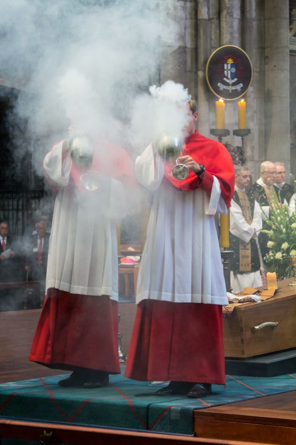 two men swinging smoking incense thuribles